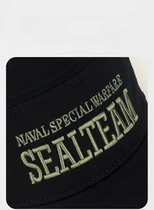 Detailed close-up of 3D embroidery on a black twill fabric outdoor sports flat cap
