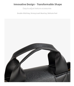 Detail of double stitching and textured leather on a black handbag strap connector