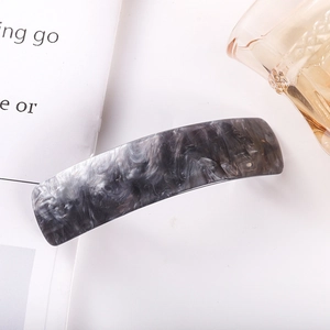 Detailed macro view of gray and white marble pattern acetate spring hair clip