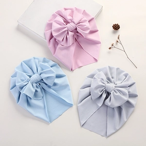 Infant waffle knit turbans with large bows in pink, blue, and grey colors