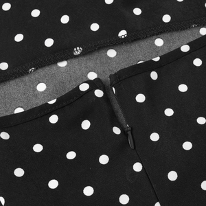 Detail of invisible zipper on a black and white polka dot summer fishtail maxi dress