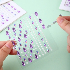 Purple teardrop rhinestones and white pearls DIY face jewels on clear backing sheet