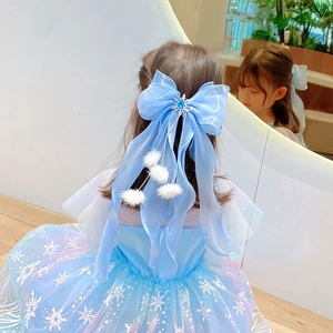 Detail of blue gradient princess dress with snowflake patterns and bow hair clip