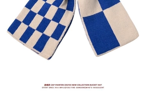 Detailed close-up of knit checkerboard texture in blue and beige with fine stitching