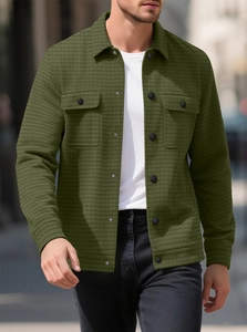 Detail of army green waffle knit jacket with chest pockets and textured plaid fabric