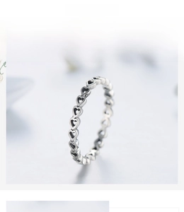 Macro shot of S925 sterling silver ring showing hollow heart patterns and S925 stamp
