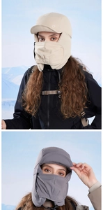 Detail of winter thermal trapper hat featuring windproof face mask and ear flaps in beige