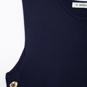 Dark blue knitted sleeveless top featuring a round hem and decorative gold shoulder button