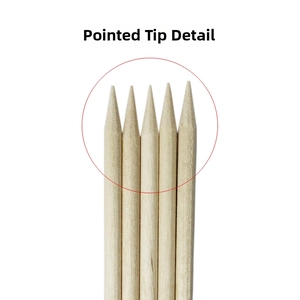 Close-up of extra-fine pointed tips on orange wood sticks for professional nail art