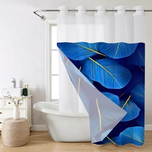 Detail of waffle weave shower curtain with blue leaf patterns and silver rings