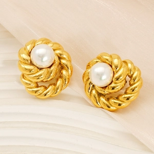 Elegant 18K gold-plated twisted hoop earrings with large pearls on silk fabric