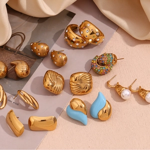 Flat lay of 18K gold-plated geometric earrings with water ripple texture and rhinestones