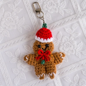 Macro view of handmade crochet gingerbread man keychain with festive Christmas hat