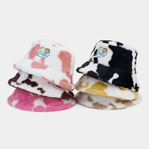 Cute cow print plush bucket hats for women in five colors with soft fleece texture