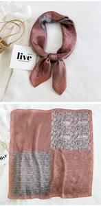 Detailed view of square silk scarf with patchwork patterns and soft satin finish