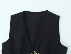 Detail of V-neck vest top with gold metal buckle closure and fine crepe fabric texture