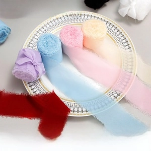 Detail view of multicolored frayed edge chiffon ribbons rolls for gift packaging