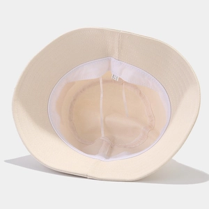 Beige cotton bucket hat with adjustable inner strap and breathable sweatband detail