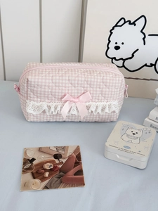 Detail of pink plaid quilted makeup bag with lace trim and sweet ribbon bow detail