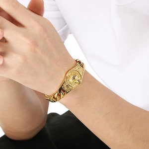 Detail of men's gold punk Cuban chain bracelet featuring a carved wolf head medallion