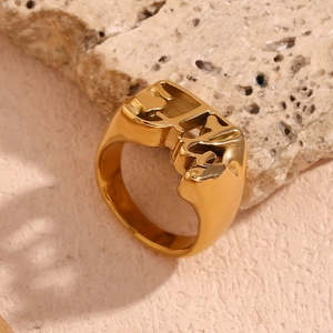 Macro shot of 18K gold plated stainless steel ring with unique hollow face silhouette