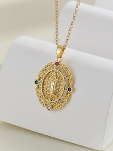 Macro shot of gold Virgin Mary pendant with colorful cubic zirconia and micro-pave crystals