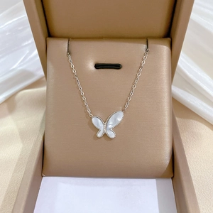 Titanium steel butterfly necklace with white mother of pearl inlay on silk background