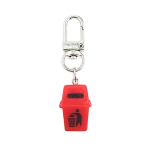 Close-up of red mini trash can keychain with metal ring on a clean white background