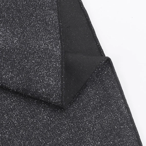 Detailed view of black off-the-shoulder dress fabric with shimmering silver sequins