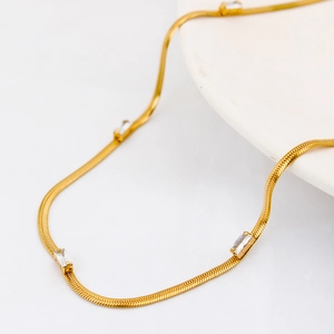 18K gold plated snake chain necklace with rectangular zircon stones on white tray