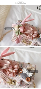 Detail of pink tweed girl handbag with plush bunny, floral decor and gold chain