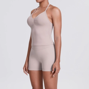 Detail view of pink seamless ribbed high-waist yoga shorts and matching sports bra fabric