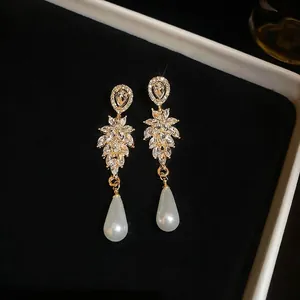 Elegant drop earrings with sparkling leaves and large white pear-shaped pearls