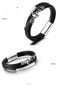 Close-up of black braided cowhide and polished stainless steel anchor charm on the bracelet