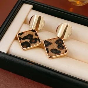 Retro geometric leopard print earrings featuring golden metal circles and square studs