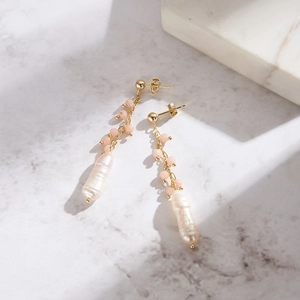Detailed macro view of S925 silver earrings with pink opals and baroque freshwater pearls