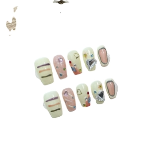 Handmade graffiti press-on nails set with glitter, colorful lines, and heart crystals