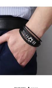 Close-up of a multilayer black leather soccer bracelet on a wrist with striped shirt