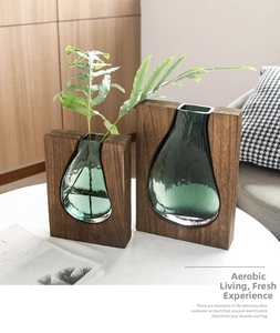 Detail of creative walnut wood frame with emerald green glass vases for home decor