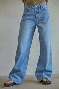 Detail view of high-waisted wide-leg denim jeans showing light blue washed texture