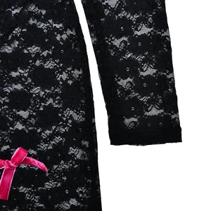 Close-up of black lace sleeve texture and pink velvet bow accent on long sleeve bodysuit