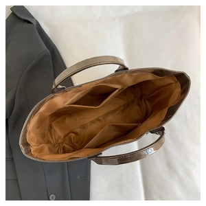 Detailed interior view of a vintage tote bag featuring a zippered pocket and large capacity