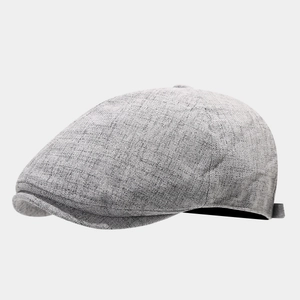 Detailed close-up showing the light gray linen texture and side buckle of the flat cap