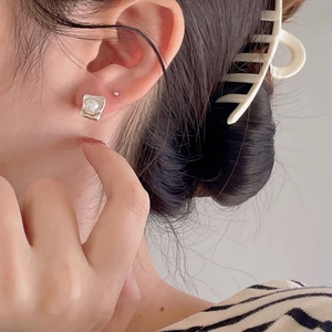 Minimalist 925 sterling silver square pearl stud earrings shown on model ear
