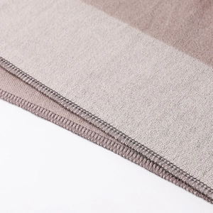 Detail shot of khaki and beige plush fabric with high-quality edge stitching craftsmanship