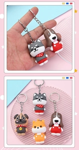 Detail showing various soft PVC cartoon dog keychains in hand and flat lay styles