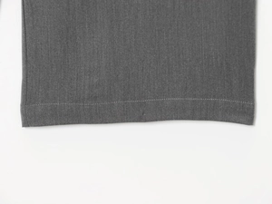 Close-up of gray fabric hem with professional stitching and high-density textile texture