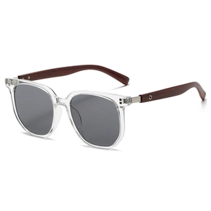 Detail view of tea-tinted polygon sunglasses with textured wood-grain temple arms