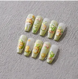 Close-up of 3D embossed nail art featuring cute animals and floral patterns on green tips
