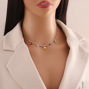 Close-up of gold stainless steel necklace with evil eyes and colorful flowers on model